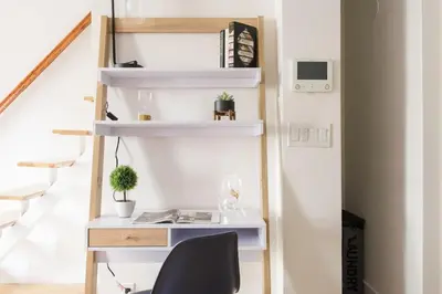 a desk in a room with a staircase with white shelves at 1597-PHN PH Duplex -Private Outdoor Deck W D in New York