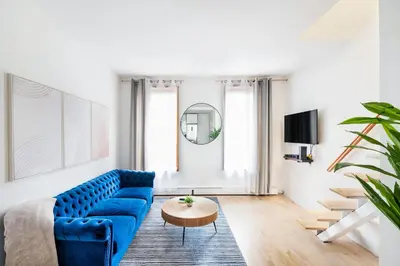 a living room with a blue couch and a table at 1597-PHN PH Duplex -Private Outdoor Deck W D in New York