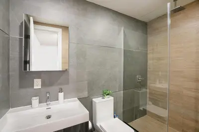 a bathroom with a sink and a toilet and a shower at 1597-PHN PH Duplex -Private Outdoor Deck W D in New York