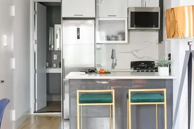 a kitchen with a counter with two stools at 1597-PHN PH Duplex -Private Outdoor Deck W D in New York