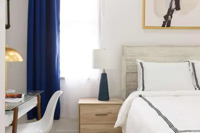 a bedroom with a bed and a desk with a lamp at 78-1A NEW Modern 1BR W&D Walk to Central Park in New York