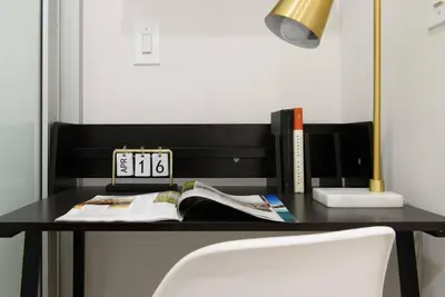 a black desk with a clock and books on it at 78-1B New 1BR prime UES WD in unit BEST VALUE in New York