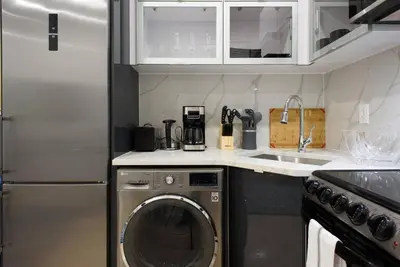 a kitchen with a washing machine and a sink at 78-1B New 1BR prime UES WD in unit BEST VALUE in New York