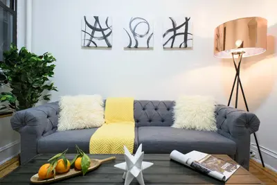 a living room with a couch and a table at 1567-1A New 2br PRIME upper East APT W&D in New York