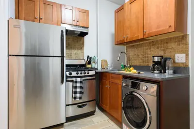 a kitchen with a stainless steel refrigerator and a dishwasher at 1567-1A New 2br PRIME upper East APT W&D in New York