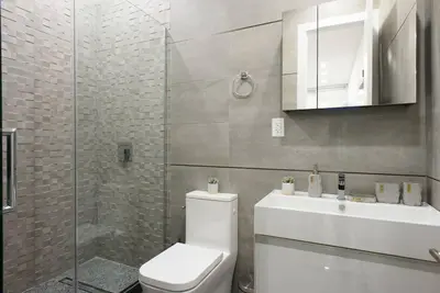 a bathroom with a toilet and a sink and a shower at 78-1D NEW Junior 1 BR Prime UES WD in unit in New York