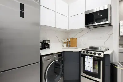 a kitchen with a washing machine and a washer at 78-1D NEW Junior 1 BR Prime UES WD in unit in New York