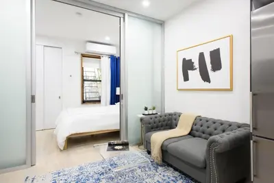 a living room with a couch and a bed at 78-2B New furnished 1BR WD walk to Central Park in New York