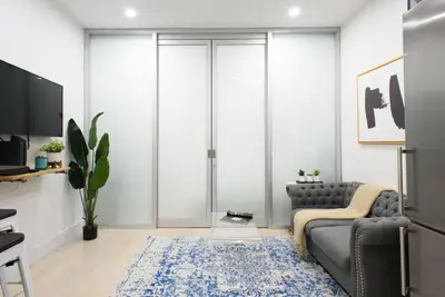 a living room with a gray couch and a blue rug at 78-2B New furnished 1BR WD walk to Central Park in New York