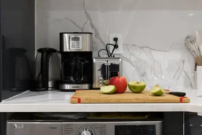 a kitchen counter with a cutting board with apples on it at 78-2B New furnished 1BR WD walk to Central Park in New York