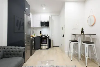 a living room with a couch and a kitchen at 78-2B New furnished 1BR WD walk to Central Park in New York