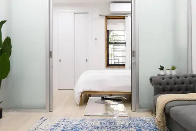 a living room with a bed and a table and a couch at 78-2B New furnished 1BR WD walk to Central Park in New York