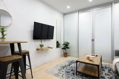 a living room with a flat screen tv on a wall at 78-2D New furnished 1BR WD walk to Central Park in New York