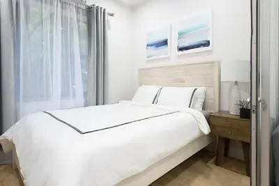 a white bedroom with a large bed and a window at 78-2D New furnished 1BR WD walk to Central Park in New York