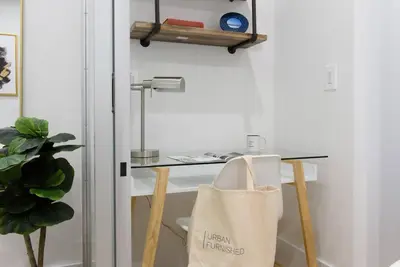 a desk with a table with a bag on it at 78-2D New furnished 1BR WD walk to Central Park in New York