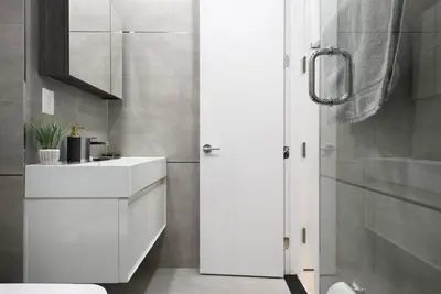 a bathroom with a white sink and a shower at 78-2D New furnished 1BR WD walk to Central Park in New York
