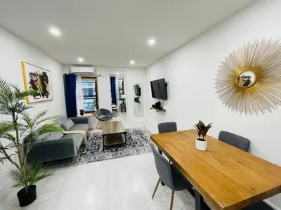 a living room with a table and a dining room at 78-3A Luxury BRAND NEW Modern 1BR W&D in New York