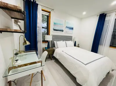 a bedroom with a bed and a desk and a sink at 78-3A Luxury BRAND NEW Modern 1BR W&D in New York