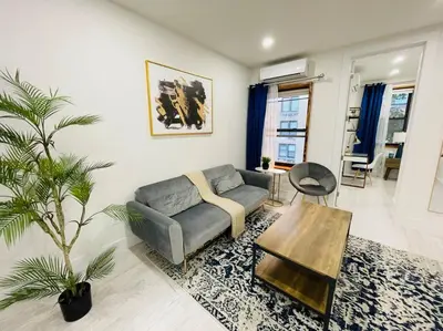 a living room with a couch and a table at 78-3A Luxury BRAND NEW Modern 1BR W&D in New York