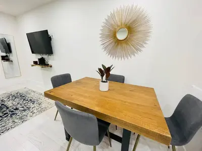 a dining room table with chairs and a mirror at 78-3A Luxury BRAND NEW Modern 1BR W&D in New York