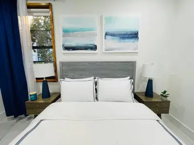 a bedroom with a large white bed and two windows at 78-3A Luxury BRAND NEW Modern 1BR W&D in New York