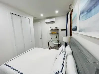 a white bedroom with a bed and a window at 78-3A Luxury BRAND NEW Modern 1BR W&D in New York