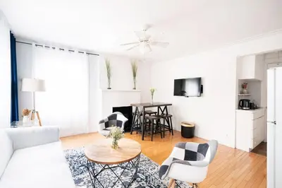 a white living room with a white couch and chairs at 11-4F Prime west village designer 1BR in New York