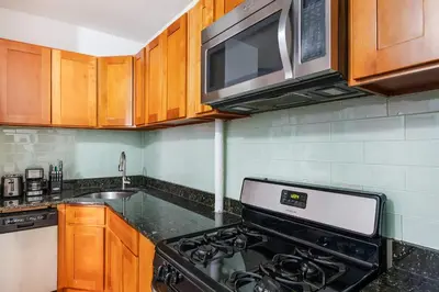 a kitchen with a stove and a microwave at 102-1A Best Value 2BR Apt Near Central Park in New York