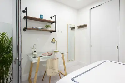 a room with a desk and a glass table at 78-3B New Junior 1 BR Prime UES WD in unit in New York