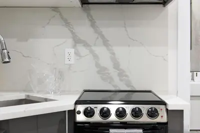 a kitchen with a stove and a sink at 78-3B New Junior 1 BR Prime UES WD in unit in New York