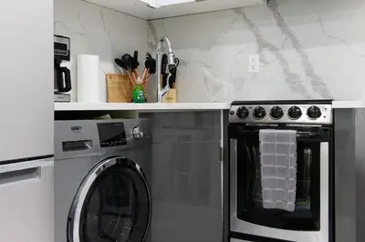 a kitchen with a washing machine and a sink at 78-3B New Junior 1 BR Prime UES WD in unit in New York
