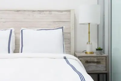 a bedroom with a white bed with a wooden headboard at 78-3B New Junior 1 BR Prime UES WD in unit in New York