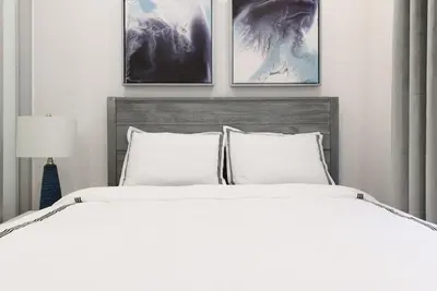 a bedroom with a bed with three pictures on the wall at 78-3D Brand new 1BR prime UES WD in unit in New York