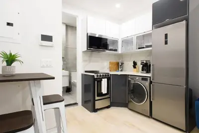 a kitchen with a refrigerator and a washer and dryer at 78-3D Brand new 1BR prime UES WD in unit in New York