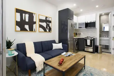 a living room with a blue couch and a table at 78-3D Brand new 1BR prime UES WD in unit in New York