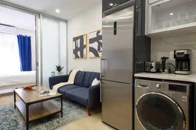 a kitchen with a washing machine and a living room at 78-3D Brand new 1BR prime UES WD in unit in New York