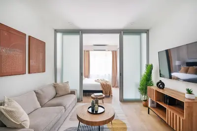 a living room with a couch and a tv at 78-4B NEW Quality 1br W&D in unit SKYLIGHTS in New York