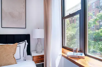 a bedroom with a bed and a window at 78-4B NEW Quality 1br W&D in unit SKYLIGHTS in New York