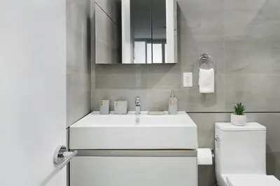 a bathroom with a white sink and a toilet at 78-4B NEW Quality 1br W&D in unit SKYLIGHTS in New York