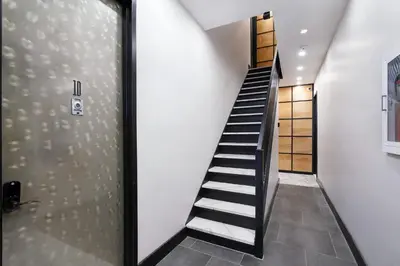 a staircase in a house with a glass door at 78-4B NEW Quality 1br W&D in unit SKYLIGHTS in New York