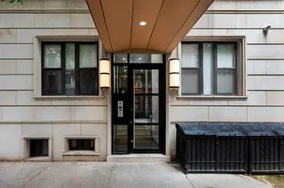 a building with a revolving door on the side of it at 78-4B NEW Quality 1br W&D in unit SKYLIGHTS in New York