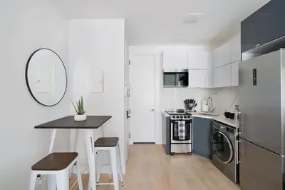 a small kitchen with a table and a counter at 78-4B NEW Quality 1br W&D in unit SKYLIGHTS in New York