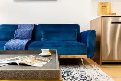 a blue couch in a living room with a coffee table at 149BK-302 New Construction 1BR WD in unit Balcony in Brooklyn