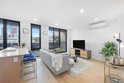 a living room with a couch and a tv at 149BK-501 NEW Prime greenpoint 2BR WD in unit in Brooklyn