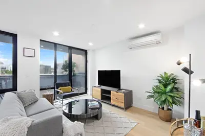 a living room with a couch and a tv at 149BK-501 NEW Prime greenpoint 2BR WD in unit in Brooklyn