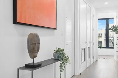 a living room with a table and a painting on the wall at 149BK-501 NEW Prime greenpoint 2BR WD in unit in Brooklyn