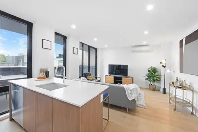 a kitchen and living room with white walls and windows at 149BK-501 NEW Prime greenpoint 2BR WD in unit in Brooklyn