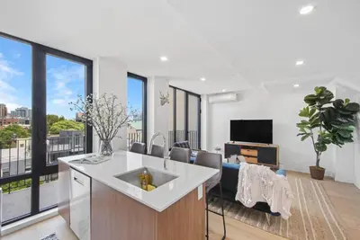 a kitchen with a sink and a living room at 149BK-601 NEW PH 2BR-2Bath Private Rooftop W D in Brooklyn