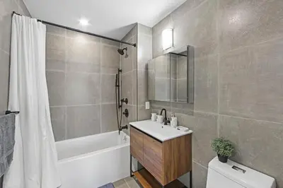 a bathroom with a sink and a tub and a toilet at 149BK-601 NEW PH 2BR-2Bath Private Rooftop W D in Brooklyn