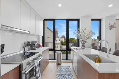 a kitchen with white appliances and a large window at 149BK-601 NEW PH 2BR-2Bath Private Rooftop W D in Brooklyn